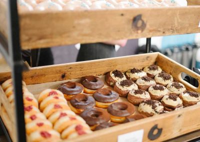 Variety of doughnuts in wooden Crosstown boxes on display