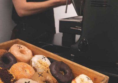 Seasonal doughnuts on display at a coffee bar